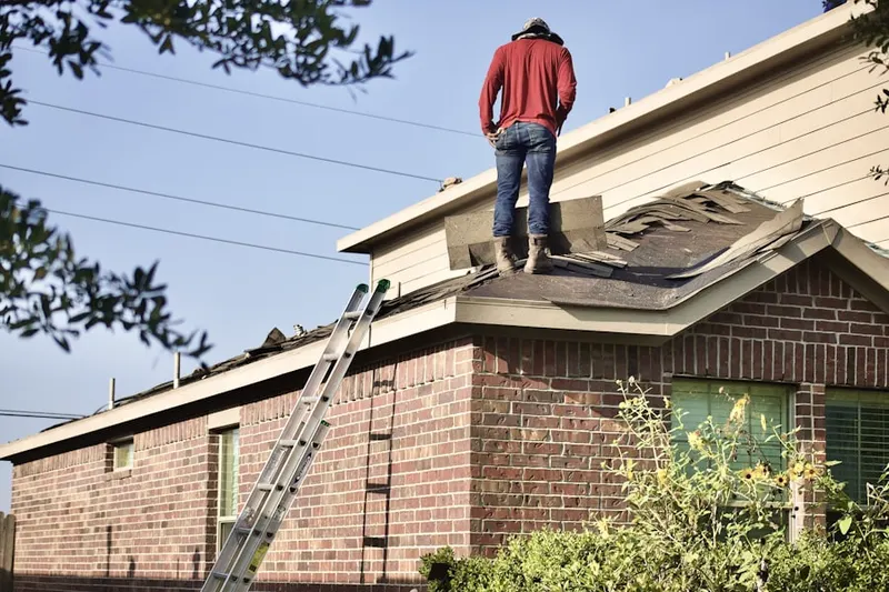 Professional roofer working on a residential roof in McLeansville